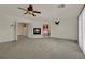 Living room featuring fireplace, ceiling fan and doorway looking into Primary bath at 4139 Abernethy Forest Pl, Las Vegas, NV 89141