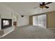 A spacious living room with fireplace and views of the backyard through the blinds at 4139 Abernethy Forest Pl, Las Vegas, NV 89141