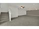 Open-concept living space features new carpet, stairs, and fan lighting at 4139 Abernethy Forest Pl, Las Vegas, NV 89141