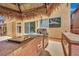 Covered outdoor kitchen with grill, countertop space, and storage, seamlessly blending indoor-outdoor living at 4139 Abernethy Forest Pl, Las Vegas, NV 89141