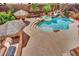 Backyard with tropical landscaping, a spa, a pool and tiki umbrellas at 4139 Abernethy Forest Pl, Las Vegas, NV 89141