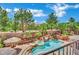 Backyard with tropical landscaping, a spa, a pool and shaded seating at 4139 Abernethy Forest Pl, Las Vegas, NV 89141