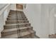 Staircase features a carpeted runner and leads to the upper level of the home at 4139 Abernethy Forest Pl, Las Vegas, NV 89141