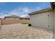 Backyard view of paver patio with artificial turf, side yard, and block wall at 4293 Nopal Serrano Ave, Las Vegas, NV 89141