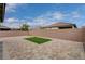 Paver patio and artificial turf surrounded by tall block wall for backyard privacy at 4293 Nopal Serrano Ave, Las Vegas, NV 89141