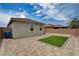 Wide angle view of the backyard features paver patio, artificial turf, and perimeter block wall at 4293 Nopal Serrano Ave, Las Vegas, NV 89141