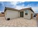 Wide angle shot of backyard with paver patio and view of sliding glass door entry at 4293 Nopal Serrano Ave, Las Vegas, NV 89141