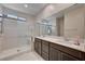 This luxurious bathroom boasts a double sink vanity and glass enclosed shower that enhances its contemporary design at 4293 Nopal Serrano Ave, Las Vegas, NV 89141