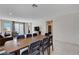 Well-lit dining area with a long wooden table, stylish chairs, and easy access to the kitchen at 4293 Nopal Serrano Ave, Las Vegas, NV 89141