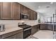 Bright kitchen includes a gas range stove, built-in microwave, and stainless steel appliances at 4293 Nopal Serrano Ave, Las Vegas, NV 89141