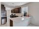 Modern kitchen features stainless steel appliances, quartz countertops, and dark wood cabinets at 4293 Nopal Serrano Ave, Las Vegas, NV 89141