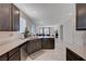 Stylish kitchen with stainless steel dishwasher and views into the living area at 4293 Nopal Serrano Ave, Las Vegas, NV 89141
