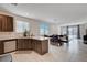 Open-concept kitchen and living area with modern appliances, tile flooring, and ample natural light at 4293 Nopal Serrano Ave, Las Vegas, NV 89141
