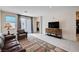 Spacious living area with tile floors, modern furnishings, and a sliding door offering outdoor access at 4293 Nopal Serrano Ave, Las Vegas, NV 89141