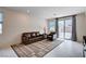 Cozy living room featuring comfortable seating, tile flooring, and sliding glass doors to the backyard at 4293 Nopal Serrano Ave, Las Vegas, NV 89141
