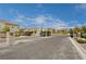 Street view of landscaped neighborhood entrance with wrought iron gates and decorative stonework at 4293 Nopal Serrano Ave, Las Vegas, NV 89141
