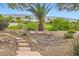 Backyard featuring desert landscaping and a decorative rock trail at 4311 Fiore Bella Blvd, Las Vegas, NV 89135