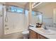 Bright bathroom featuring a shower-tub combination and a single sink vanity with a neutral color palette at 4311 Fiore Bella Blvd, Las Vegas, NV 89135