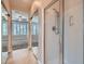Neutral bathroom boasts mirrored closet doors and glass shower at 4311 Fiore Bella Blvd, Las Vegas, NV 89135