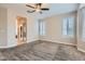 Bright bedroom features a ceiling fan, neutral walls, and windows with plantation shutters at 4311 Fiore Bella Blvd, Las Vegas, NV 89135