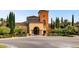 Beautiful community clubhouse has a stately entrance, colorful architecture and meticulously manicured landscaping at 4311 Fiore Bella Blvd, Las Vegas, NV 89135