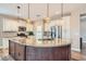 Gourmet kitchen with granite countertops, stainless steel appliances, and an island with pendant lighting at 4311 Fiore Bella Blvd, Las Vegas, NV 89135