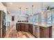 Kitchen island with stainless steel appliances and hardwood floors at 4311 Fiore Bella Blvd, Las Vegas, NV 89135