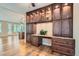 Custom built-in office area features beautiful wood cabinets, drawers and a granite countertop on top of wood floors at 4311 Fiore Bella Blvd, Las Vegas, NV 89135