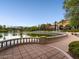 Tranquil pond view with a building, palm trees and landscaping features a peaceful escape to nature at 4311 Fiore Bella Blvd, Las Vegas, NV 89135