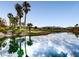 A serene pond features a beautiful sky reflection and a golf course in the distance at 4311 Fiore Bella Blvd, Las Vegas, NV 89135