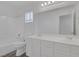 Bathroom boasts a double sink vanity, framed mirror, shower-tub, and neutral decor at 4807 Leadership Ct, North Las Vegas, NV 89031