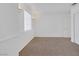 Clean bedroom with neutral carpet, base molding, white walls, and natural light from the window at 4807 Leadership Ct, North Las Vegas, NV 89031