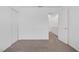 This carpeted bedroom features white walls, a closet, and an open doorway to the bathroom at 4807 Leadership Ct, North Las Vegas, NV 89031