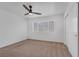 Simple bedroom with neutral walls, ceiling fan, window, and closet at 4807 Leadership Ct, North Las Vegas, NV 89031