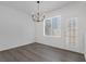 Cozy dining area with a chandelier, adjacent to the door, offers modern comfort at 4807 Leadership Ct, North Las Vegas, NV 89031