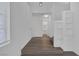 Bright entryway featuring wood-look floors, built-in shelves, and a view of the bathroom at 4807 Leadership Ct, North Las Vegas, NV 89031