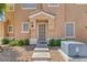 Two-story home with a neutral colored exterior and charming front porch at 4807 Leadership Ct, North Las Vegas, NV 89031