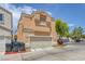 Two-story home with an attached two-car garage and neutral colored exterior at 4807 Leadership Ct, North Las Vegas, NV 89031