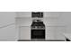 Well-equipped kitchen showcasing stainless steel range and microwave, plus white cabinets at 4807 Leadership Ct, North Las Vegas, NV 89031