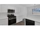 Modern kitchen features white cabinetry, stainless steel appliances, and a stylish light fixture at 4807 Leadership Ct, North Las Vegas, NV 89031
