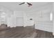 Bright living room features hardwood floors, a ceiling fan, and custom built in shelving at 4807 Leadership Ct, North Las Vegas, NV 89031