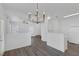 Open living area with modern chandelier, neutral walls, and durable flooring at 4807 Leadership Ct, North Las Vegas, NV 89031