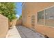 Private backyard patio with block wall and access door at 4807 Leadership Ct, North Las Vegas, NV 89031