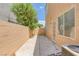 Private backyard patio with block wall, access door, and AC unit at 4807 Leadership Ct, North Las Vegas, NV 89031