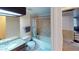 Bathroom with tiled shower/tub and vanity with granite countertop and dark wood cabinet at 4998 Schumann Dr, Las Vegas, NV 89146