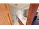 Bright bathroom featuring a vanity with granite countertop, sink, and large mirror at 4998 Schumann Dr, Las Vegas, NV 89146