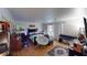 Spacious primary bedroom with hardwood floors, a decorative area rug, and abundant natural light at 4998 Schumann Dr, Las Vegas, NV 89146