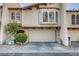 Charming townhome with a two-car garage, desert landscaping, and arched windows at 4998 Schumann Dr, Las Vegas, NV 89146