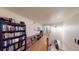 Hallway with hardwood floors, filled with bookcases of various heights for ample storage at 4998 Schumann Dr, Las Vegas, NV 89146
