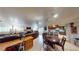 Open-concept living room featuring a fireplace, tile floors, and seamless kitchen access at 4998 Schumann Dr, Las Vegas, NV 89146